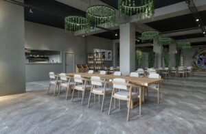 Spacious modern restaurant interior featuring minimalist furniture and artistic wall decor.