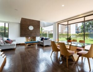 Spacious living and dining area with glass windows and modern furnishings.